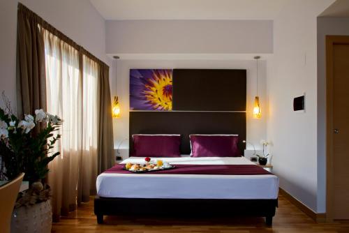 a bedroom with a large bed with purple pillows at Hotel Gravina San Pietro in Rome