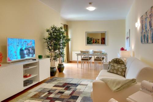 a living room with a couch and a tv at Marina Coast Residence in Albufeira