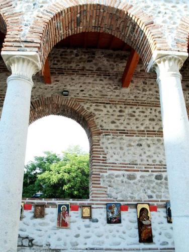 a building with an arch with pictures on it at Main Street Apartment in Sandanski