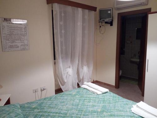 a bedroom with a bed with two towels on it at Albergo Ristorante Pizzeria Del Viale in Palazzo Adriano