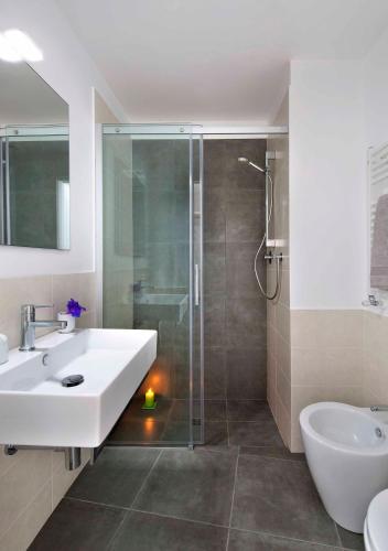 a bathroom with a white sink and a shower at Le calandre in Ventimiglia