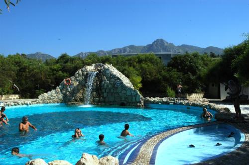 a group of people in a pool in a water park at Riviera Beach Bungalows in Kyrenia
