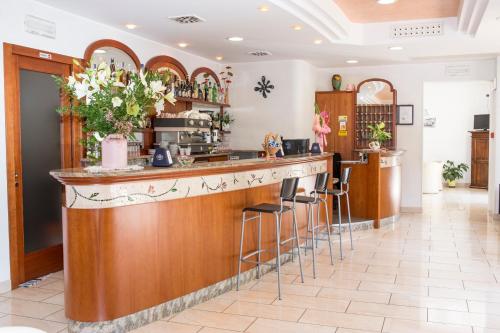 a bar in a restaurant with stools at Hotel Silvia in Misano Adriatico
