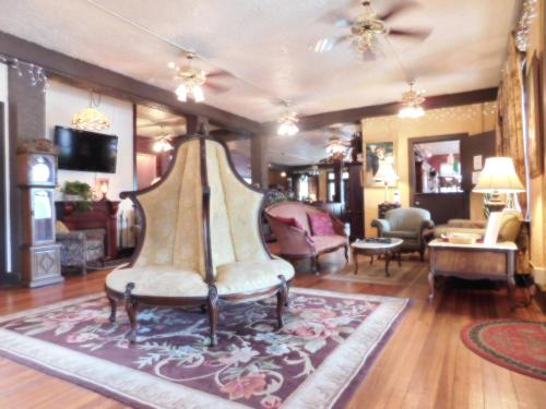 a living room with a chair and a couch at Cassadaga Hotel and Spiritual Center in Cassadaga