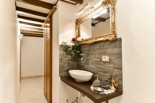 a bathroom with a sink and a mirror on the wall at Loft Pantheon in Rome
