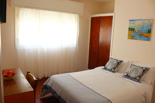 Ένα ή περισσότερα κρεβάτια σε δωμάτιο στο Hotel San Martin