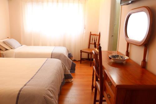 Ένα ή περισσότερα κρεβάτια σε δωμάτιο στο Hotel San Martin