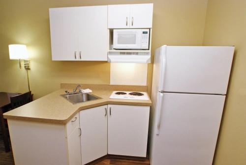 a kitchen with a white refrigerator and a sink at Extended Stay America Suites - Chicago - Elmhurst - O'Hare in Elmhurst