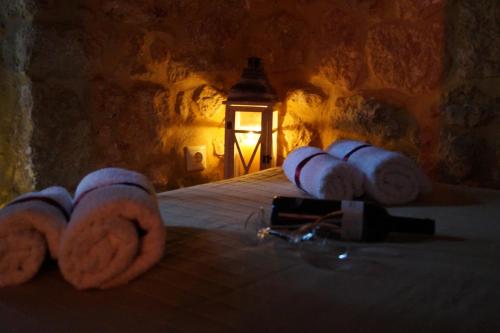 a bedroom with a bed with towels on it at Niko's Stone Guest House in Plitra