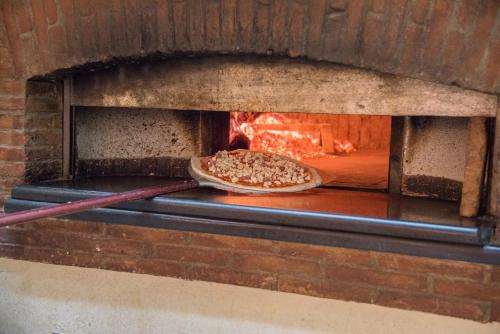 a pizza is coming out of a brick oven at Il Raduno in Tramonti