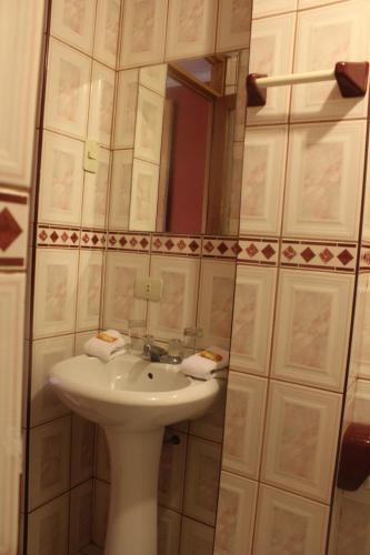 a bathroom with a sink and a mirror at Eureka Lodge in Ollantaytambo