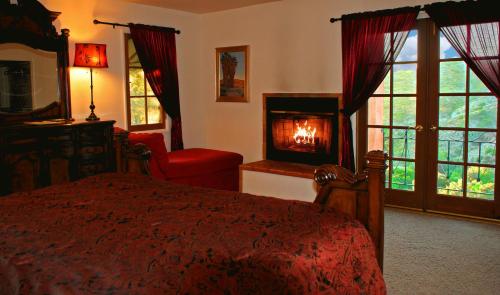 a bedroom with a bed and a fireplace in it at Topanga Canyon Inn Bed and Breakfast in Topanga