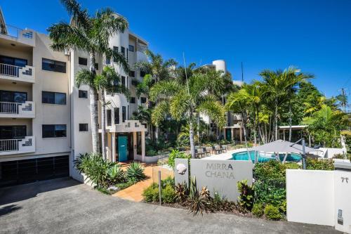 a view of the entrance to a hotel with palm trees at Mirra Chana in Mooloolaba