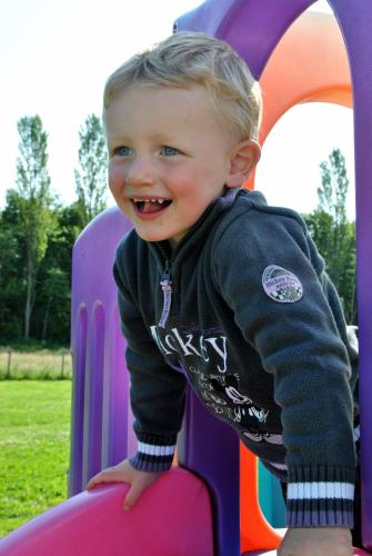 a young boy is playing on a toy trampoline at B&B Hoeve de Schapenkop in Ronse