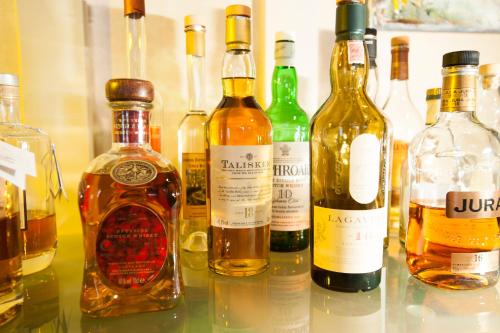 a group of bottles of alcohol sitting on a table at Hotel Gerig in Wassen