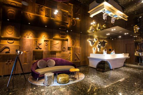 a living room with a couch and a fireplace at Airline Inn - Kaohsiung Station in Kaohsiung