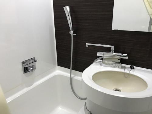 a bathroom with a white toilet and a shower at Seto Park Hotel in Seto