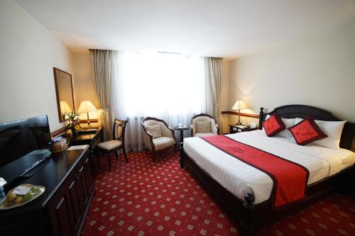 a hotel room with a bed and a television at Sammy Dalat Hotel in Da Lat