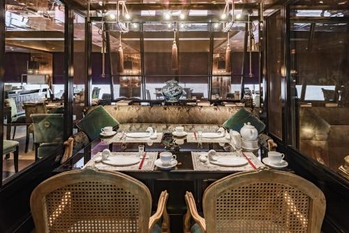 a dining room with a table and chairs at Palais de Chine Hotel in Taipei