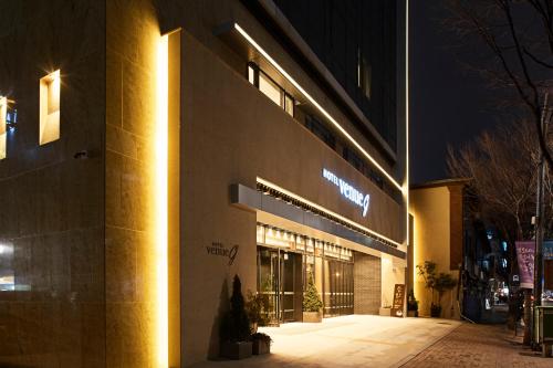 a building with lights on the side of it at night at Hotel Venue-G Seoul in Seoul