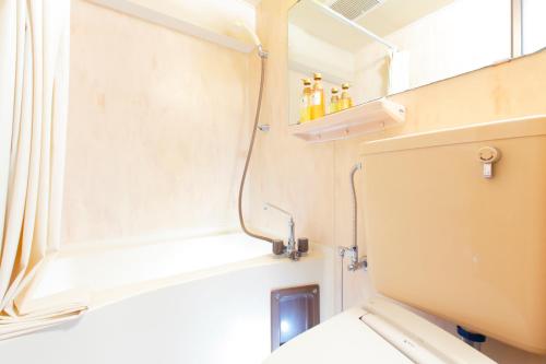 a bathroom with a toilet and a window at FLEXSTAY INN Ekoda in Tokyo