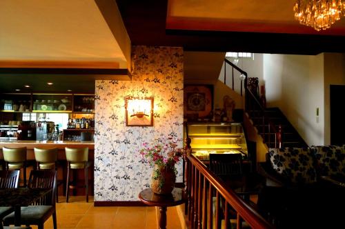 a restaurant with a bar and a counter with chairs at Villa High Wharf in Wanli