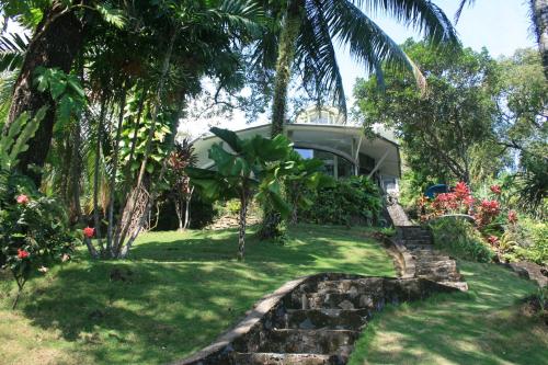a house in the middle of a yard with trees at Puncak Air Manis Residence in Padang