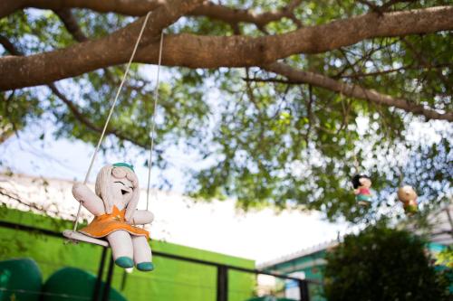 a teddy bear hanging from a tree at Samui Verticolor in Chaweng