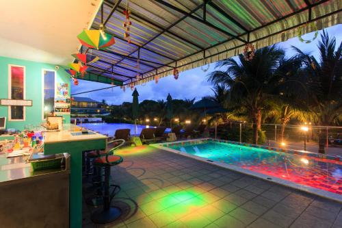 a swimming pool with a bar and a resort at Samui Verticolor in Chaweng