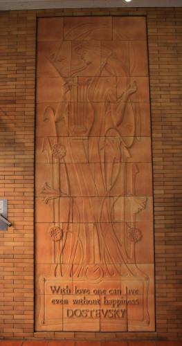 a wooden wall with a painting of a woman on it at Toyokawa Grand Hotel in Toyokawa