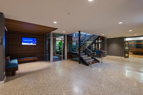 a living room with a staircase leading to a stairwell at Trinity on Hampden in Perth