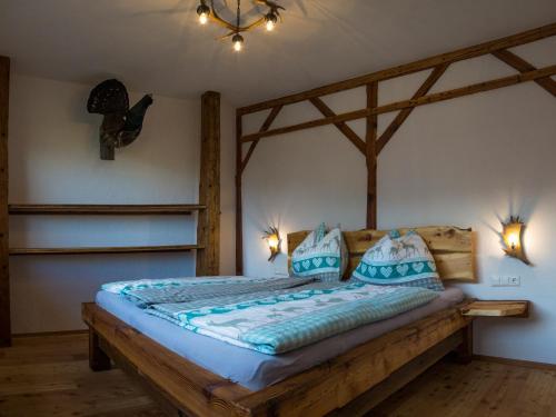 a bedroom with a wooden bed with two pillows at Troadkasten in Kötschach