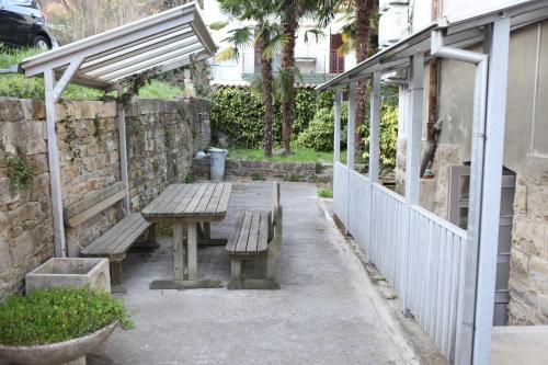 a picnic bench in a courtyard next to a building at Apartments Morski Svet Portorož in Portorož