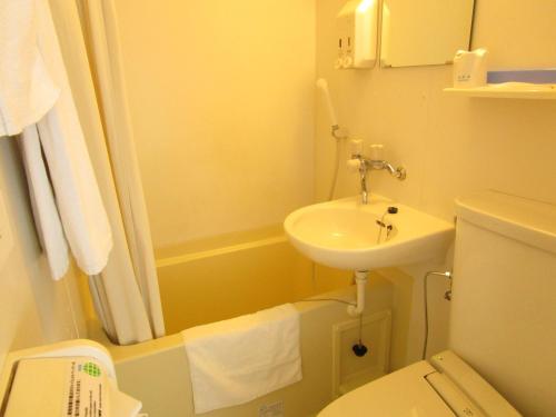 a bathroom with a sink and a toilet and a shower at Smile Hotel Utsunomiya Higashiguchi in Utsunomiya