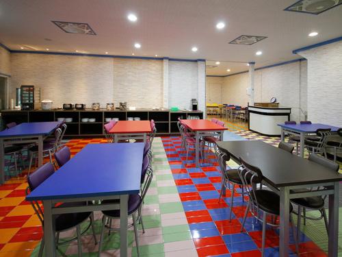 a classroom with tables and chairs in a cafeteria at Chihpan City in Wenquan