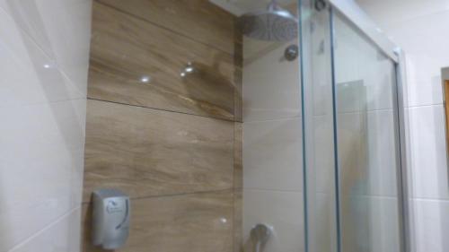 a shower with a glass door in a bathroom at Hostal Restaurante La Masía in Villareal