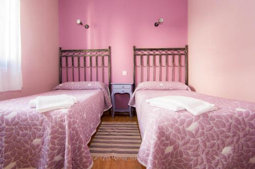 オヨス・デル・エスピーノにあるEl Leñador IIのピンクの壁のドミトリールーム ベッド2台