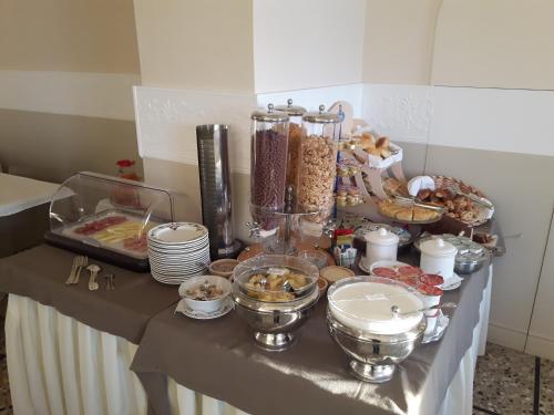 a table with a buffet of food on it at Hotel Eden Alaxi Hotels in Alassio