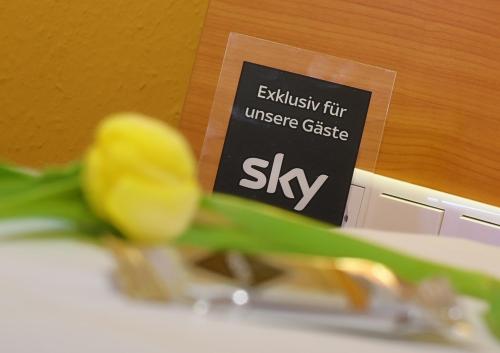a yellow tulip in front of a sign at TIPTOP Hotel Burgschmiet Garni in Nürnberg