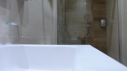 a bathroom with a shower with a glass door at Hostal Restaurante La Masía in Villareal