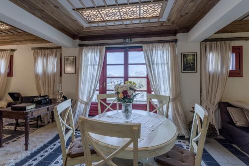 a dining room with a table and chairs at Meliteion Traditional Hotel in Asprangeloi