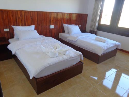 Tempat tidur dalam kamar di Phouluang Hotel