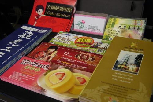 a table with a bunch of books and some food at King Town Hotel in Luodong