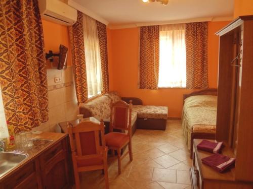 a bedroom with a bed and a sink in a room at Horváth Apartmanház in Orosháza