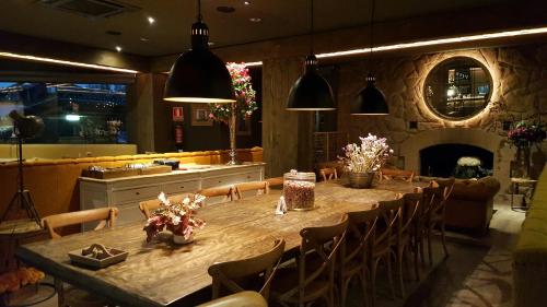a dining room with a long table and a fireplace at Hotel Gran Sol in Solsona