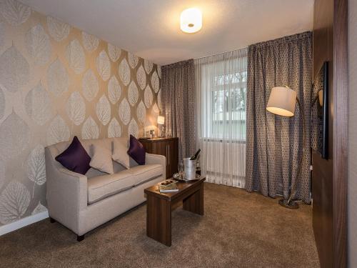 a living room with a couch and a table at The Melbreak Hotel in Great Clifton