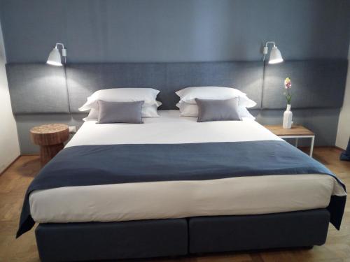 a bedroom with a large bed with white pillows at Piccola Torre Maison in Vigevano