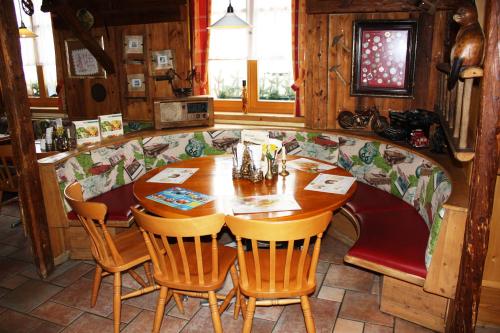 a dining room with a wooden table and chairs at Autobahnrestaurant & Motorhotel Zöbern in Zöbern