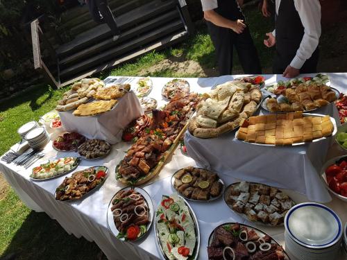 a table with many different types of food on it at Lisine smeštaj Vodopad in Strmosten