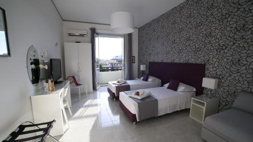 ローマにあるFHR-Appartamento a San Giovanniのベッドルーム1室(ベッド2台、ソファ、テレビ付)